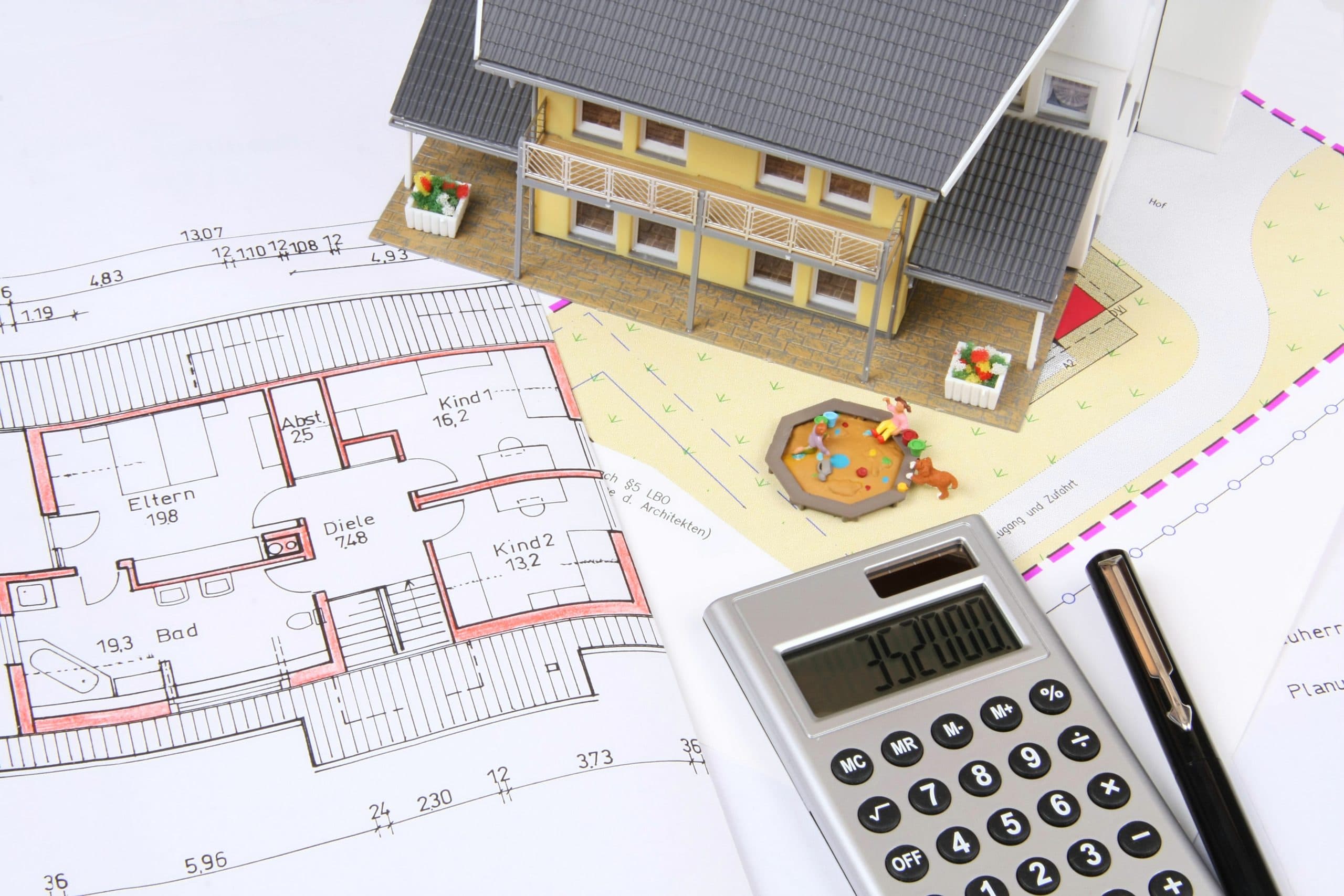 Architect plans with a model house and calculator, our services for owners